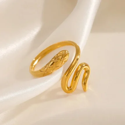 Gold-plated stainless steel snake wrap ring on satin background