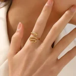 Gold-plated stainless steel snake wrap ring on satin background