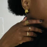 Gold plated stainless steel ring with a small marquise cut clear stone on a thin band