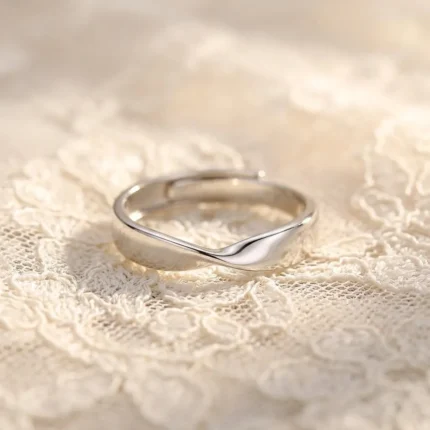Silver stainless steel twisted mobius adjustable ring on lace background