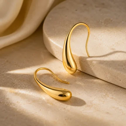 Fluid Amber Dewdrop Earrings gold drop earrings on white marble surface