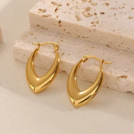 Pair of gold-plated stainless steel V-shaped hoop earrings with polished finish on a neutral background