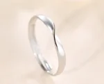 Silver stainless steel twisted mobius adjustable ring on lace background
