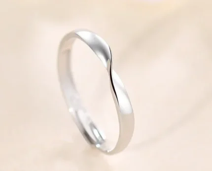 Silver stainless steel twisted mobius adjustable ring on lace background