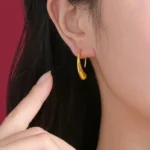Fluid Amber Dewdrop Earrings gold drop earrings on white marble surface